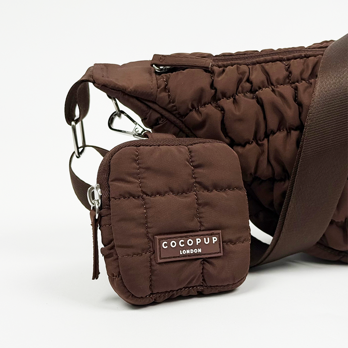 Brown crescent-shaped crossbody dog walking bag with matching pouch and poop bag dispenser from Coconut Lane.