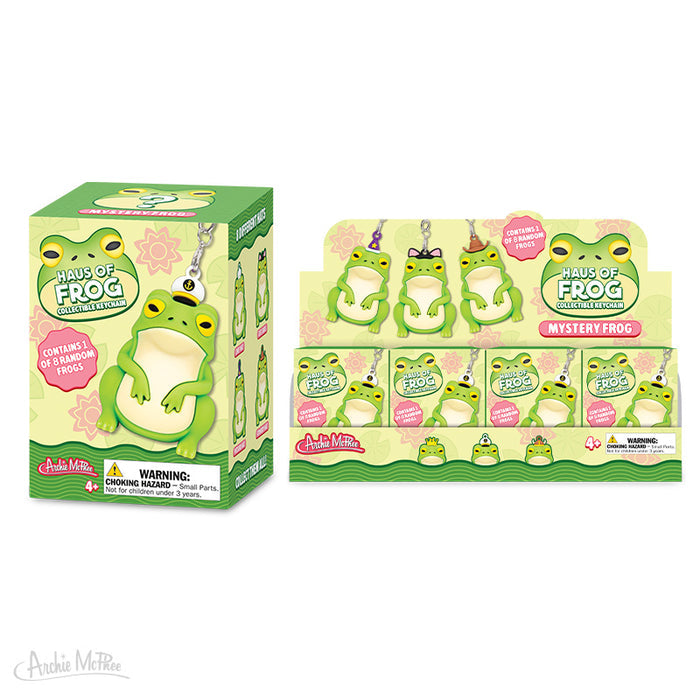 Two packages of the Haus of Frog Blind Box feature cute figural frog keychains with playful green designs and surprise branding, just like a collectible mystery box.