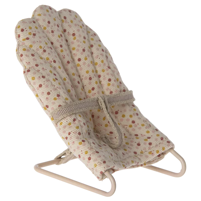 A beige baby sitter accessory for toy rabbits and baby mice, covered in fabric with a polka dot pattern.