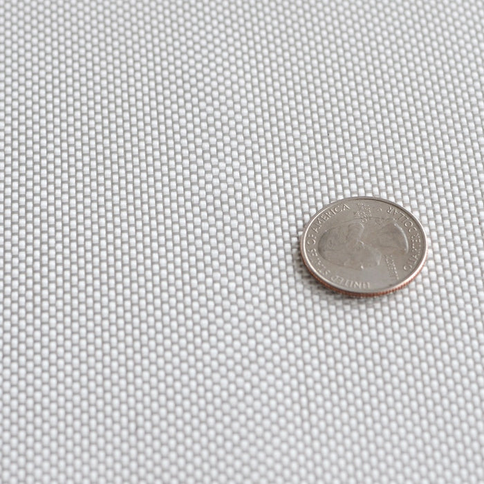 Six ounce fiberglass cloth laid flat with quarter on top to show plain weave size reference. 60 inch width.