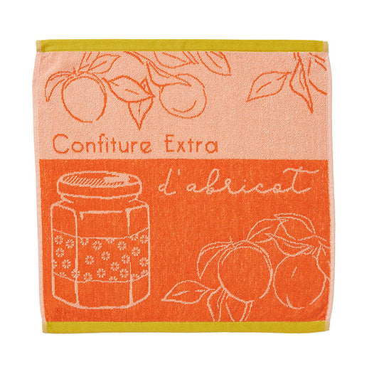 An orange cotton tea towel with a terrycloth texture, featuring illustrations of apricots and leaves, and text that reads 'Confiture Extra d'abricot'.