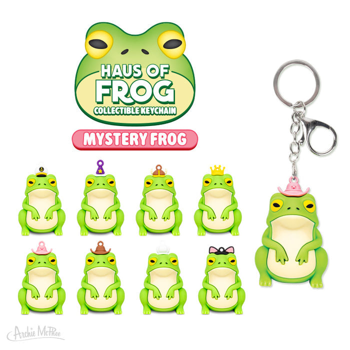 The Haus of Frog Blind Box features nine unique figural frog keychains with different hats and accessories, plus an extra-large keychain with a pink hat—an ideal collectible or fun mystery box surprise.
