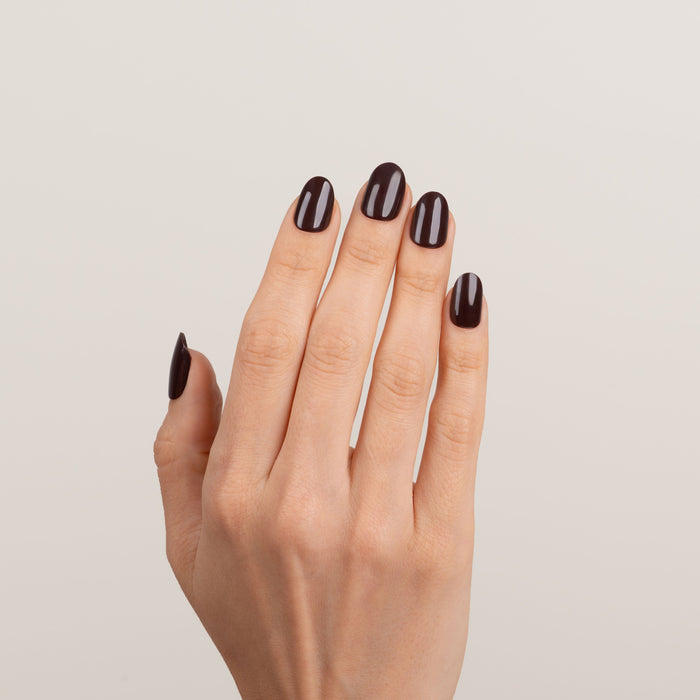 Hand with dark brown nails