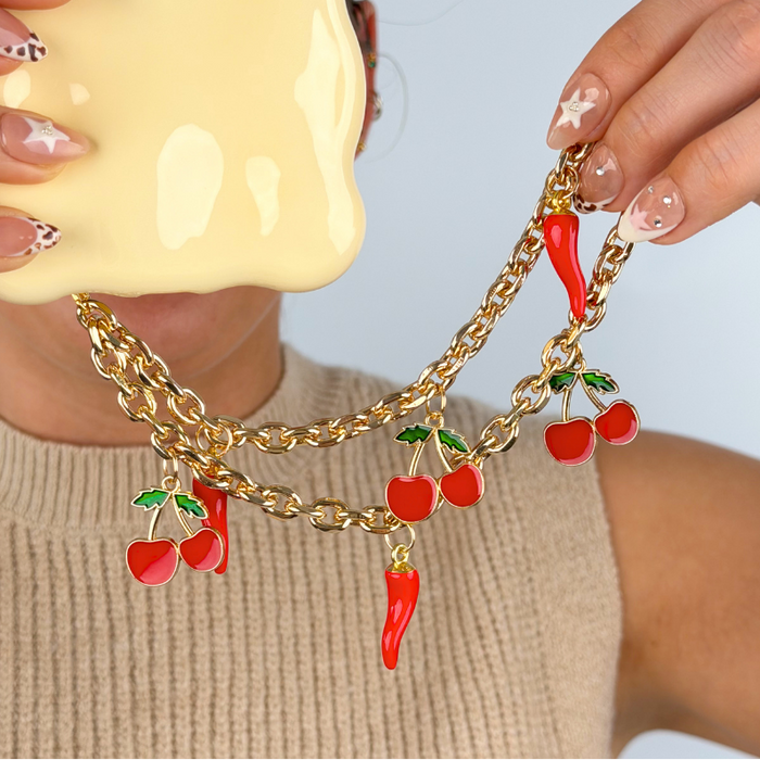 Girl holding cherry spice phone strap close up image in studio