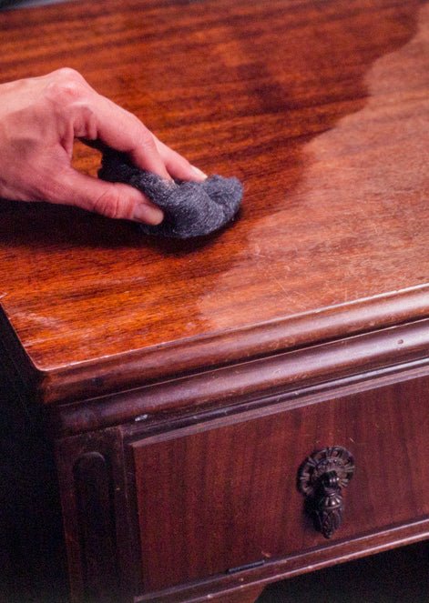 Side-by-side view of a scratched wood cabinet before and after using Howard Restor-A-Finish to erase blemishes.
