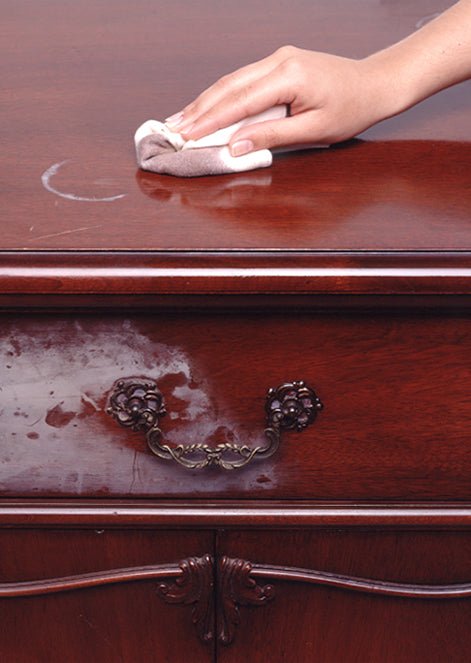 Applying Howard Restor-A-Finish to a vintage wood table with a soft cloth to restore the original shine.