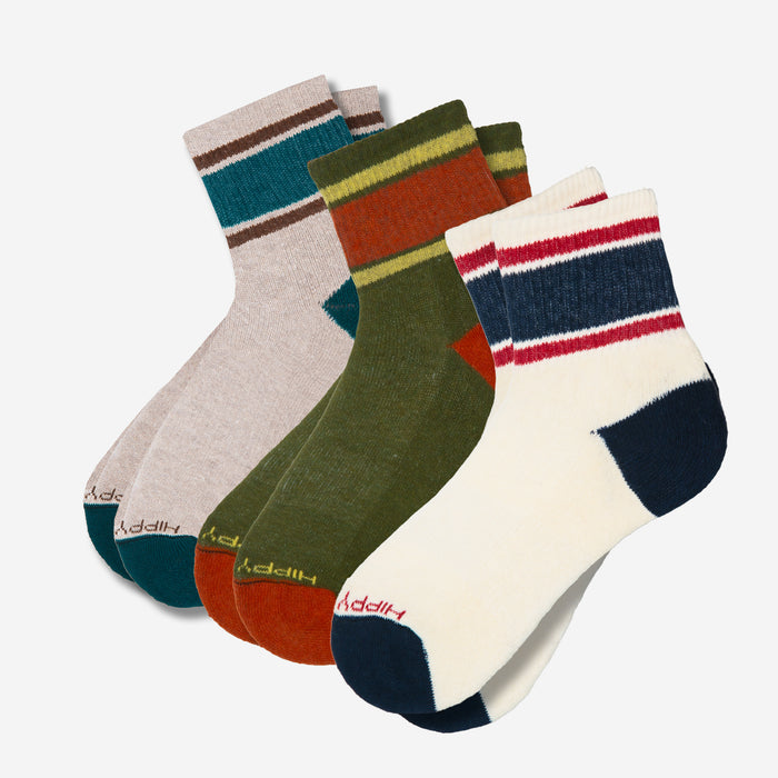 Set of four pairs of colorful socks with striped patterns on a white background
