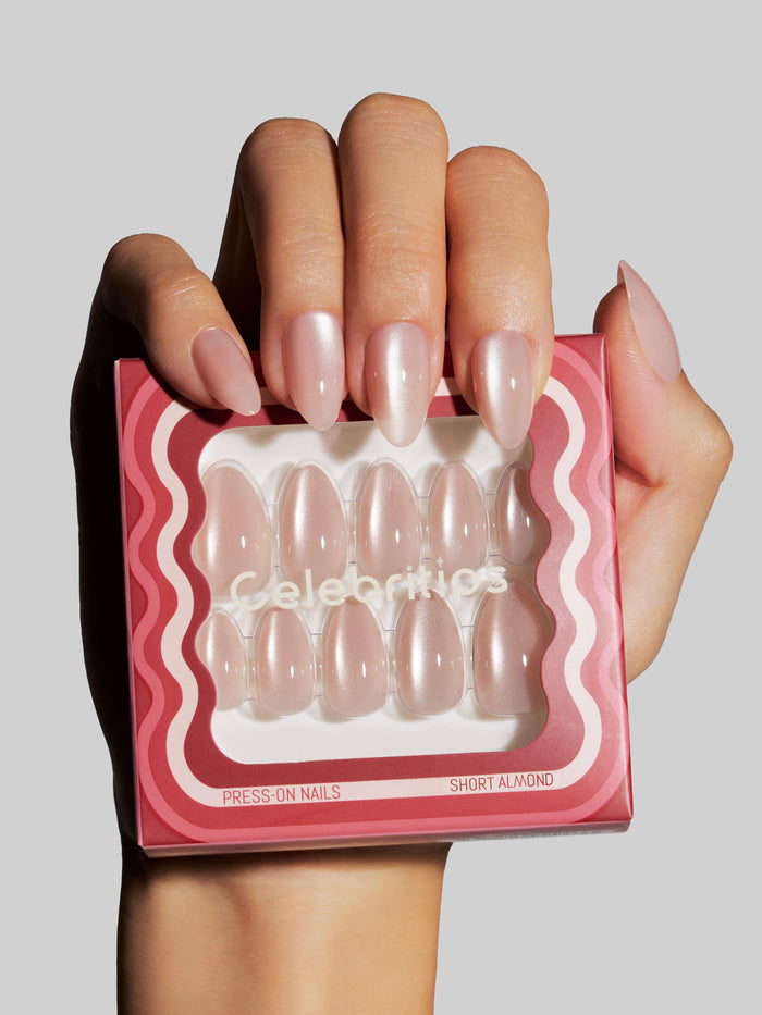 Hand holding a box of press-on nails with 'Celebritips' branding.