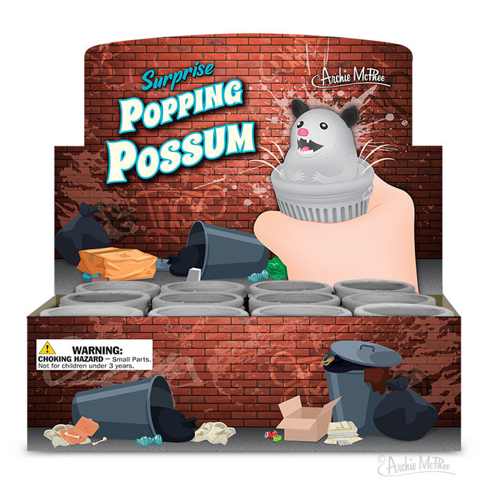 The Surprise Popping Possum toys are made from soft rubber and provide a playful and enjoyable experience. They come in an illustrated display box that shows toy possums emerging from trash cans, accompanied by a warning label regarding small parts.