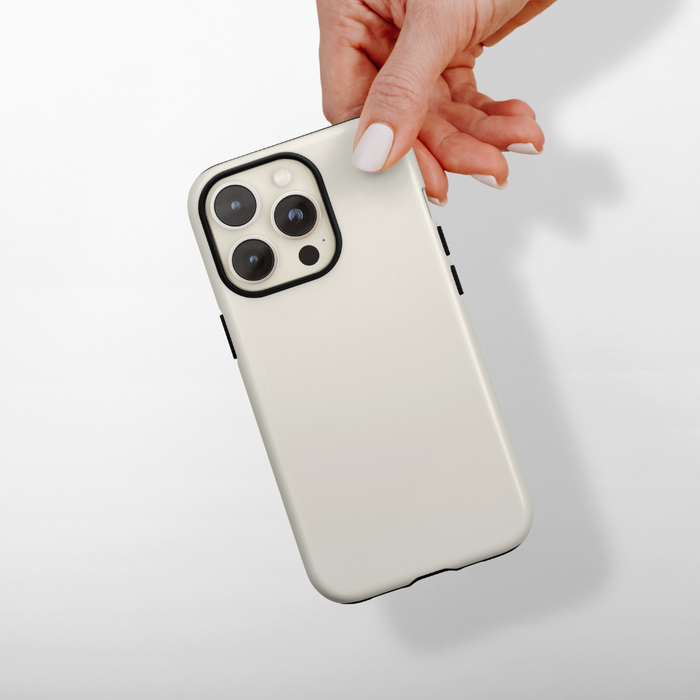 Hand with white nails holding Coconut Lane Tough Phone Case in Cloud Dancer design, shown against a white background.