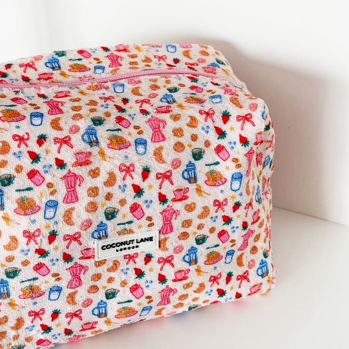 Colorful terry towel makeup bag with bold Breakfast Club lettering by Coconut Lane. Soft textured zip pouch.