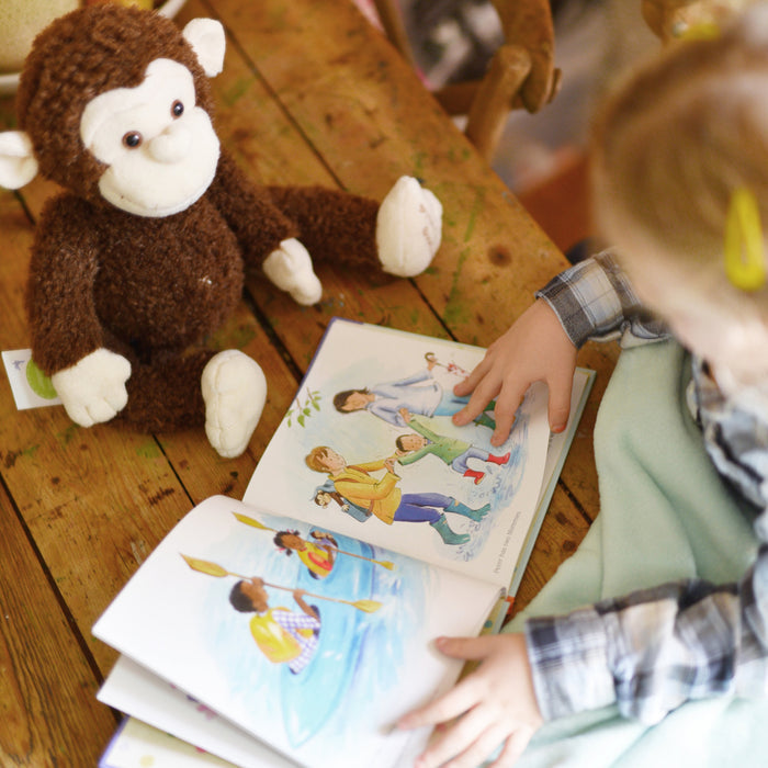 Lifestyle image of “What does a family look like?” Book with Your Buddy Boodles Plush.