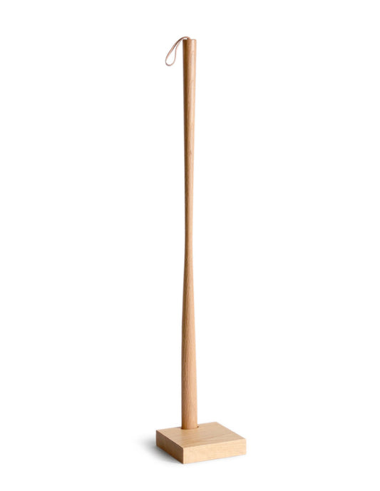 Wooden shoe horn with square base on by Nalata Nalata and Kime a white background